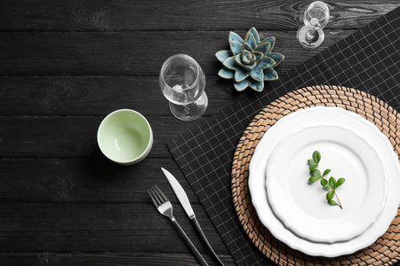 Elegant table setting on black wooden background, flat layの写真素材