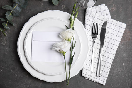 Elegant festive table setting on dark gray background, flat layの写真素材