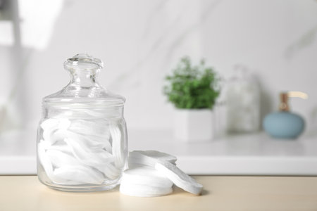 Cotton pads on wooden table in bathroomの写真素材