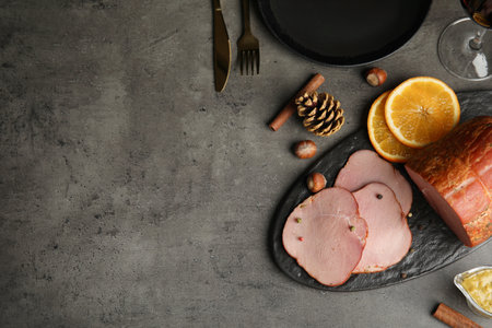 Flat lay composition with delicious ham on gray table, space for text. christmas dinnerの写真素材