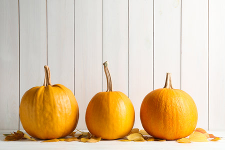 Ripe pumpkins on table against wooden background. holiday decorationの写真素材