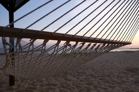 Empty hammock on the beach at sunset. Time to relaxの写真素材