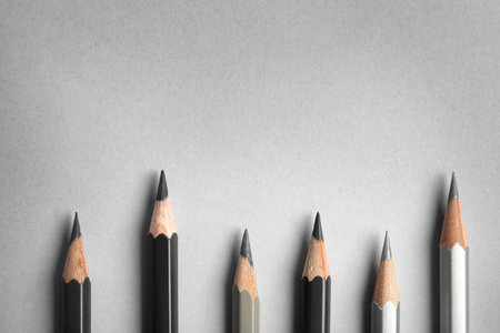 Flat lay composition with color pencils on gray background, space for textの写真素材