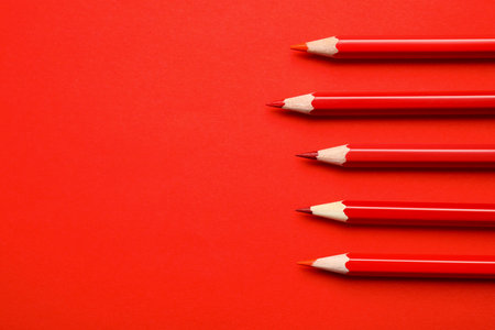Flat lay composition with color pencils on red background. Space for textの写真素材