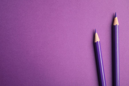 Flat lay composition with color pencils on purple background. Space for textの写真素材