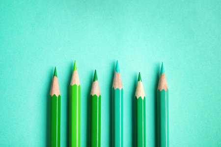 Flat lay composition with color pencils on turquoise backgroundの写真素材