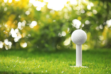 Golf ball on tee at green courseの写真素材