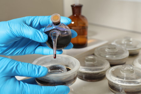 Scientist doing nitrogen titration of soil sample at table, closeup. laboratory research