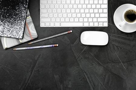 Flat lay composition with computer keyboard and notebooks on gray background, space for text....
