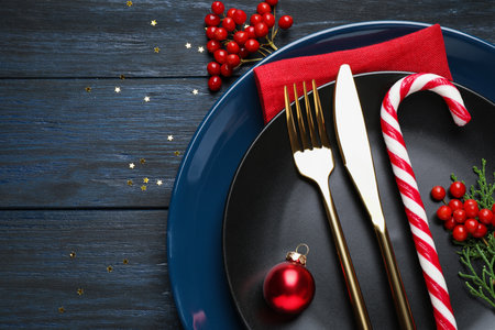Beautiful Christmas table setting on dark wooden background, flat layの写真素材