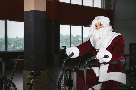 Young Santa Claus training in modern gymの写真素材