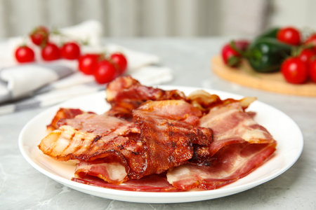 Slices of tasty fried bacon on light marble table indoorsの写真素材