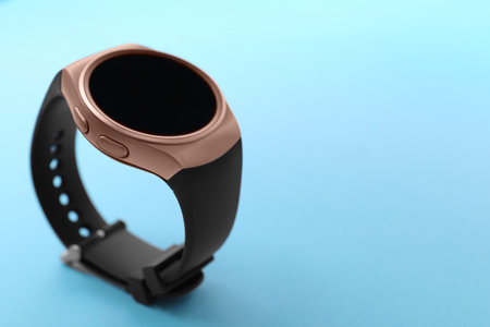 Trendy smart watch on light blue background, space for textの写真素材