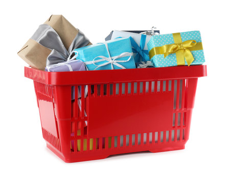Red shopping basket with different gifts on white backgroundの写真素材