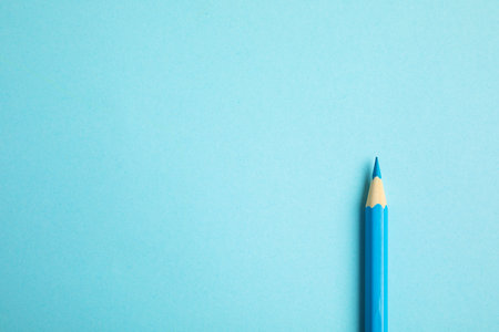 Color pencil on light blue background. Space for textの写真素材