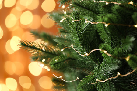 Decorated Christmas tree against blurred lights on background. bokeh effectの写真素材