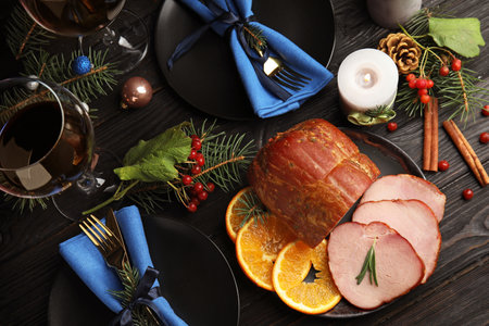 Flat lay composition with delicious ham on black wooden table. christmas dinnerの写真素材
