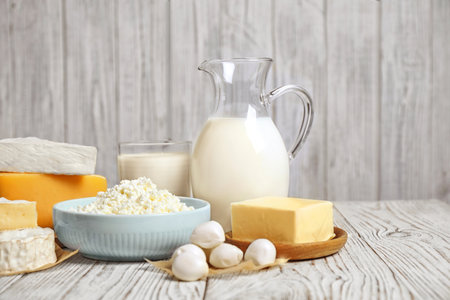 Different delicious dairy products on white wooden tableの写真素材