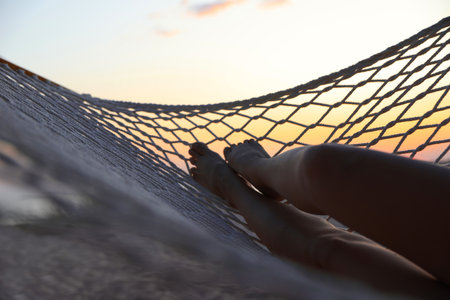 Young woman relaxing in hammock outdoors, closeupの写真素材