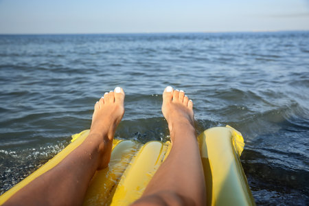 Beautiful young woman on inflatable mattress in sea, closeupの写真素材