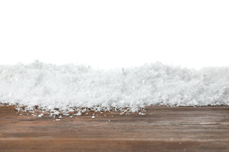 Heap of snow on wooden surface against white background. christmas seasonの写真素材