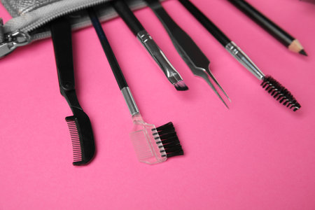 Set of professional eyebrow tools on pink backgroundの写真素材
