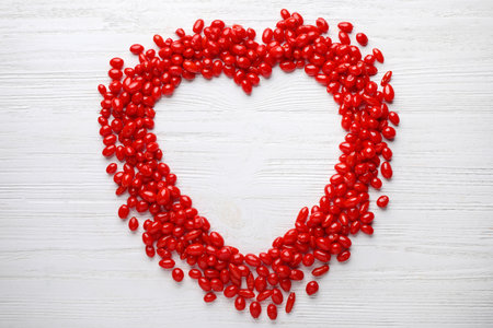 Frame made of fresh ripe goji berries on white wooden table, flat lay. Space for textの写真素材