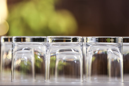 Set of empty glasses on gray table against blurred backgroundの写真素材