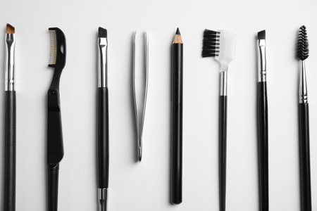 Set of professional eyebrow tools on white background, flat layの写真素材