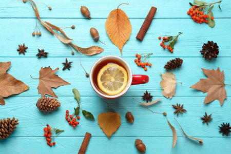 Flat lay composition with cup of hot drink on blue wooden table. Cozy autumn atmosphereの写真素材