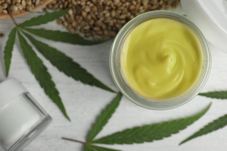 Flat lay composition with hemp cream on white wooden table. organic cosmeticsの写真素材