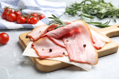 Sliced raw bacon on light gray marble tableの写真素材