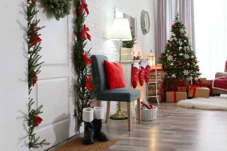 Stylish interior with beautiful Christmas tree and decorative fireplaceの写真素材