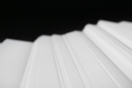 Stack of blank paper on dark background, closeupの写真素材