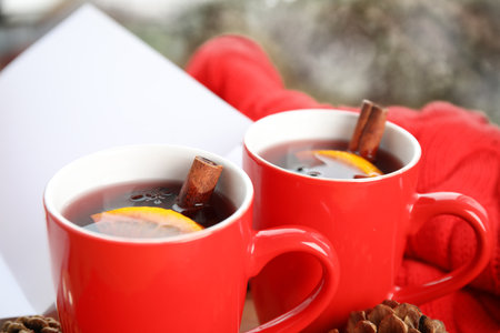 Cups of hot winter drink on blurred background, closeupの写真素材