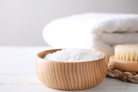 White sea salt for spa scrubbing procedure on wooden tableの写真素材
