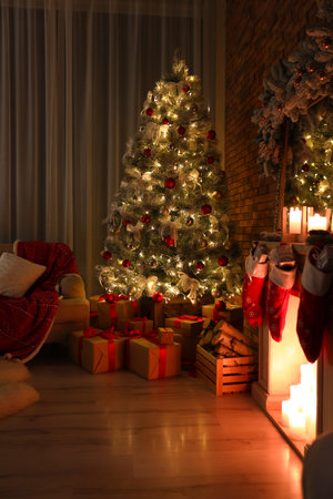 Stylish room interior with beautiful Christmas tree in the eveningの写真素材