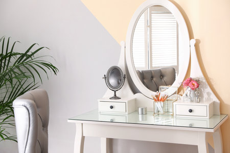 Modern dressing table with flowers in stylish room interiorの写真素材
