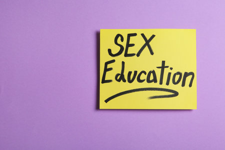 Note with phrase "SEX EDUCATION" on violet background, top viewの写真素材