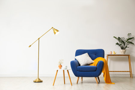 Stylish living room interior with comfortable furniture near white wallの写真素材