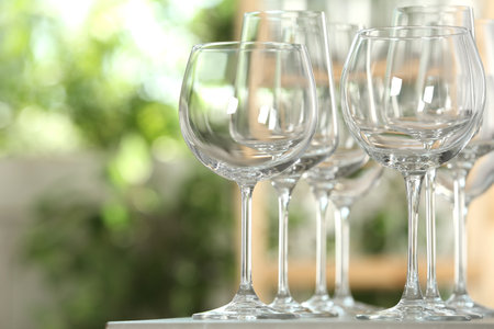 Empty glasses on table against blurred backgroundの写真素材