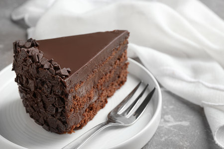 Delicious fresh chocolate cake served on gray table, closeupの写真素材