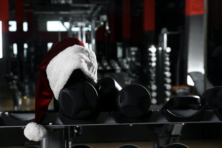 Santa hat on stand with dumbbells in modern gymの写真素材