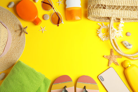 Flat lay composition with beach objects on yellow background. Space for textの写真素材