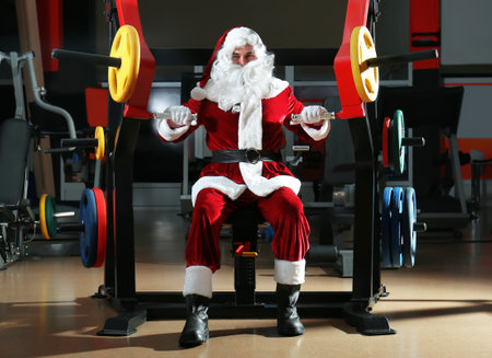 Young Santa Claus training in modern gymの写真素材