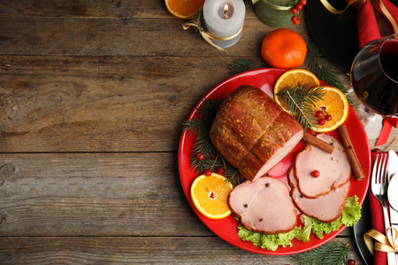 Flat lay composition with delicious ham on wooden table, space for text. christmas dinnerの写真素材