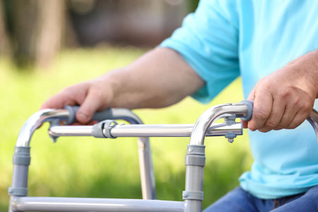 Elderly man with walking frame outdoors, closeup. medical help