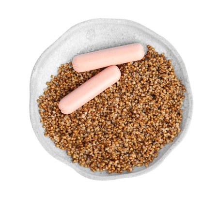 Delicious buckwheat porridge with sausages on white background, top viewの写真素材