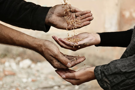 Poor homeless people sharing food outdoors, closeupの写真素材