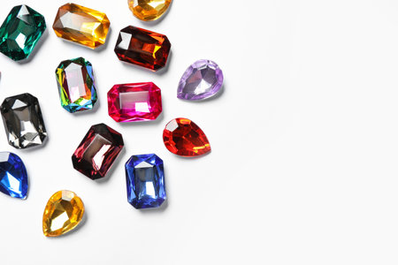 Different beautiful gemstones on white background, top viewの写真素材